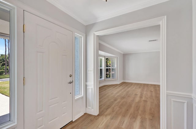 entrance foyer featuring light hardwood / wood-style floors and ornamental molding