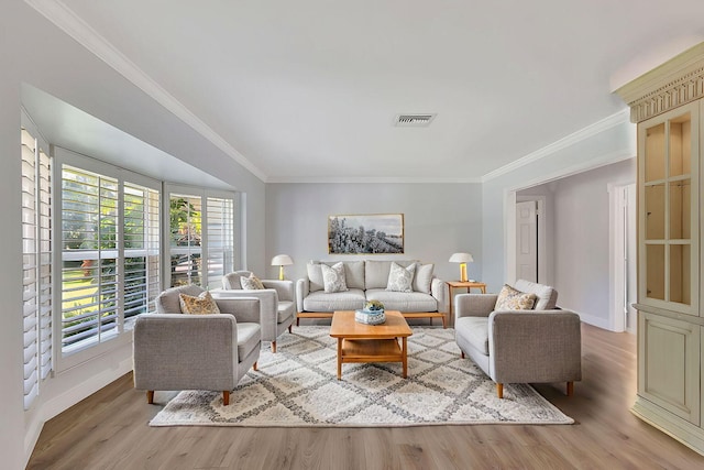 living room featuring light wood-type flooring and crown molding