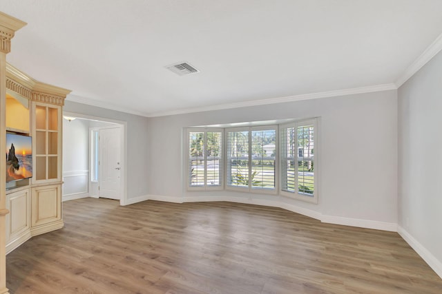 unfurnished room with light hardwood / wood-style floors and ornamental molding