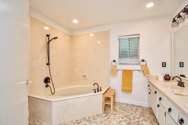 bathroom with vanity and shower with separate bathtub