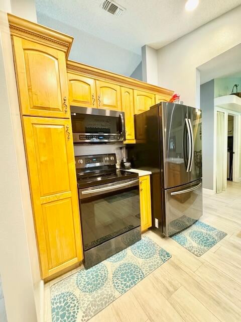 kitchen featuring stainless steel appliances and light wood-type flooring