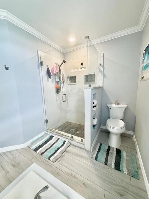 bathroom featuring walk in shower, crown molding, wood-type flooring, and toilet