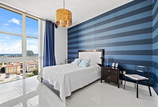 bedroom with light tile patterned floors and a textured ceiling