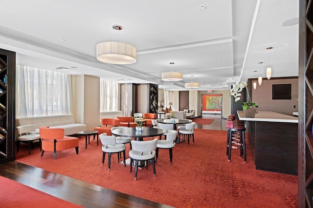 dining area featuring bar area and hardwood / wood-style floors