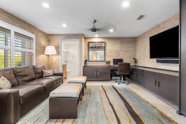 living room featuring built in desk and ceiling fan