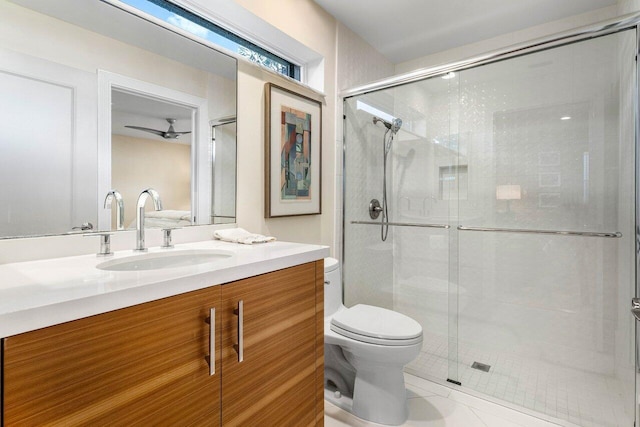 bathroom featuring tile patterned floors, vanity, toilet, and walk in shower