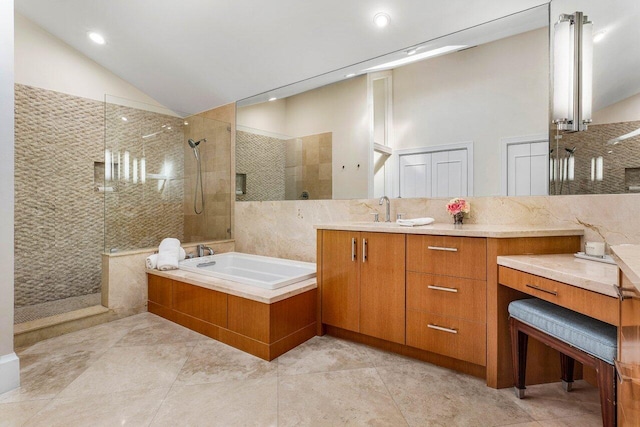 bathroom featuring tile patterned floors, vanity, independent shower and bath, and vaulted ceiling