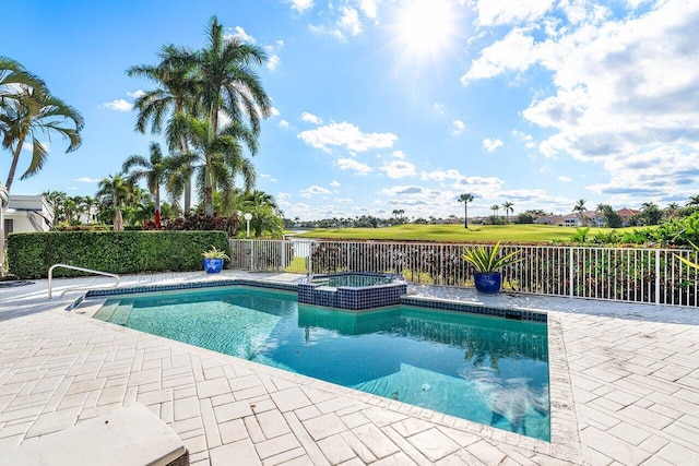 view of pool with a patio area and an in ground hot tub