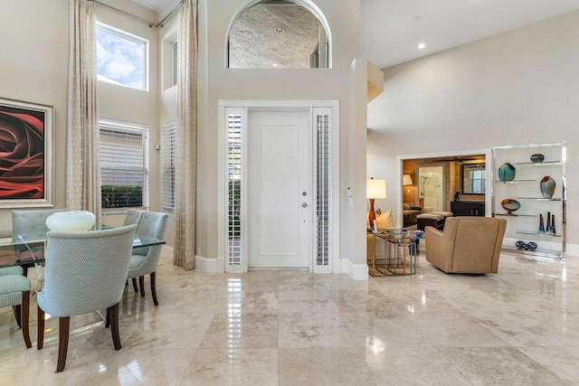 foyer entrance with a towering ceiling