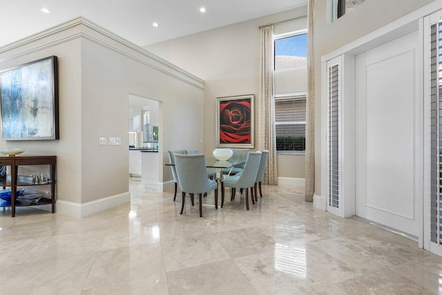 dining space with a towering ceiling