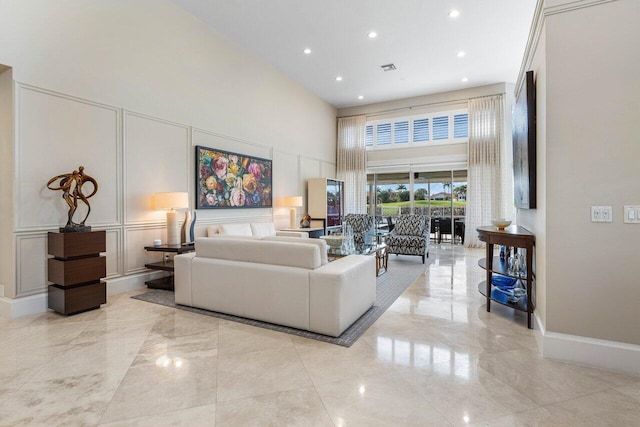 living room featuring a high ceiling