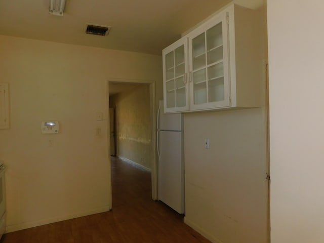 corridor with dark hardwood / wood-style floors