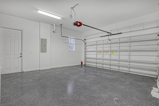 garage with electric panel and a garage door opener