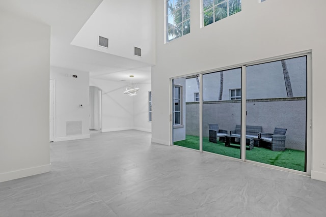 unfurnished room featuring a high ceiling