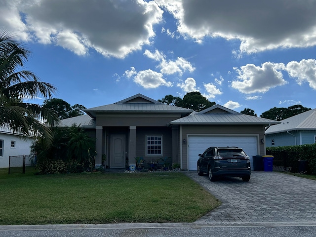 view of front of property featuring a front yard and a garage