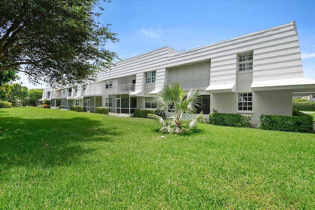 rear view of property with a yard