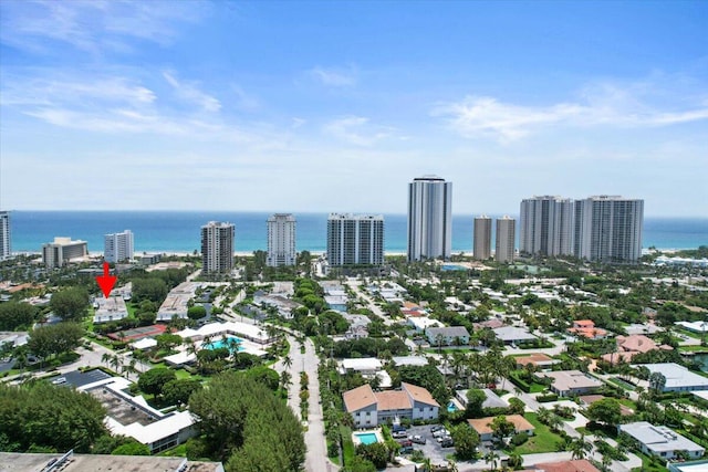 birds eye view of property featuring a city view and a water view