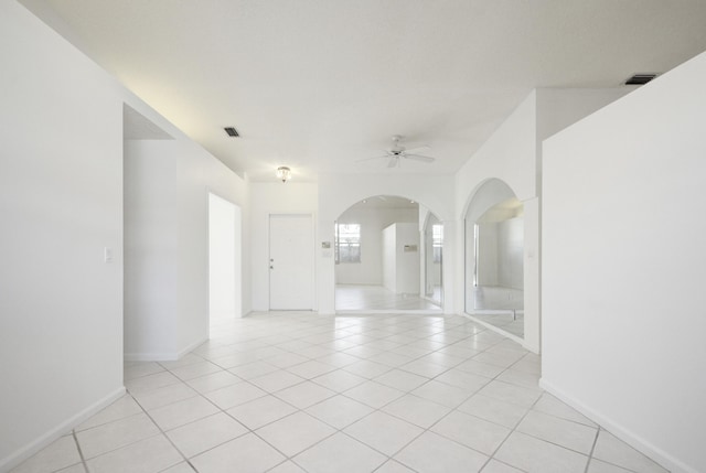 spare room with ceiling fan and light tile patterned floors