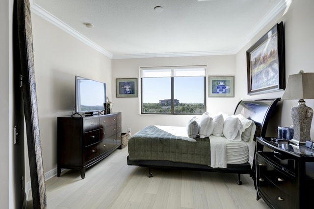 bedroom featuring light hardwood / wood-style flooring and ornamental molding