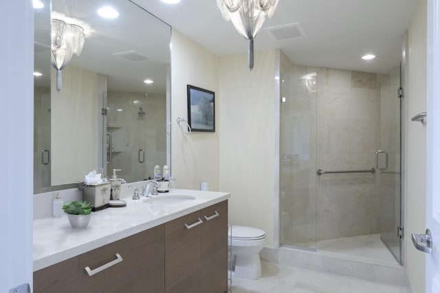 bathroom featuring vanity, an inviting chandelier, toilet, and an enclosed shower