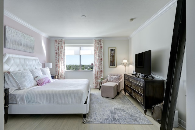 bedroom featuring light hardwood / wood-style floors and crown molding