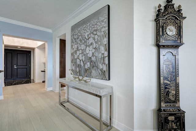 hallway featuring crown molding and light wood-type flooring