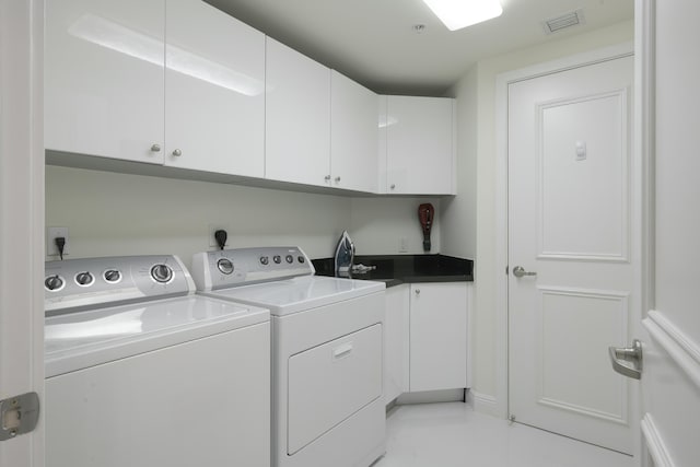 laundry area with cabinets and separate washer and dryer