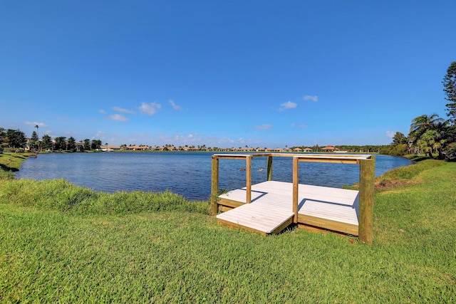 dock area featuring a lawn and a water view