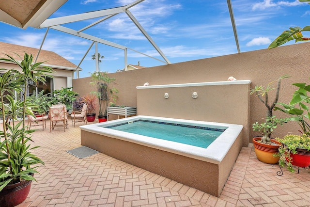 view of swimming pool with an in ground hot tub and a patio