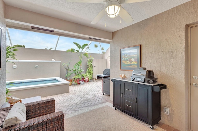 interior space with ceiling fan and a textured ceiling