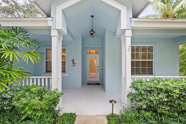 property entrance with stucco siding