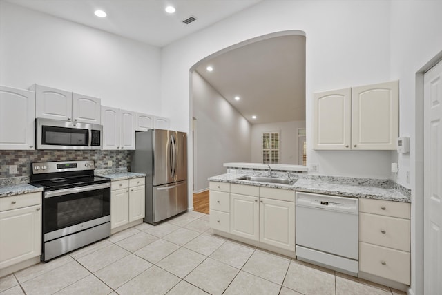 kitchen featuring white cabinets, light tile patterned flooring, sink, and stainless steel appliances