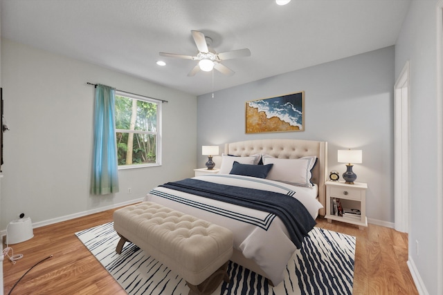 bedroom with ceiling fan and light hardwood / wood-style floors