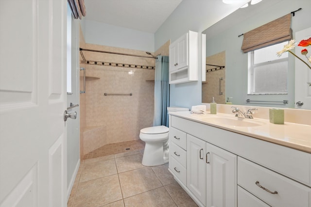 bathroom with toilet, vanity, tile patterned floors, and walk in shower