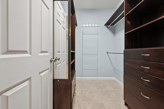 spacious closet featuring light tile patterned floors