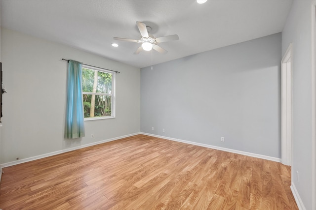 unfurnished room featuring ceiling fan and light wood-type flooring