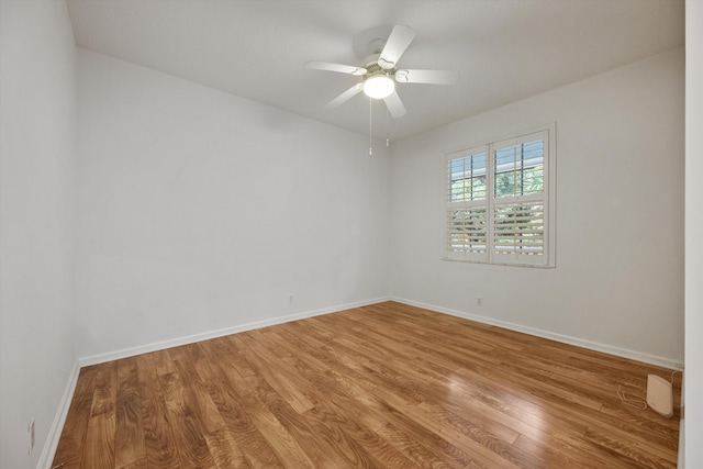 empty room featuring hardwood / wood-style flooring and ceiling fan