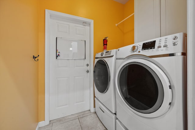 washroom with light tile patterned floors and separate washer and dryer