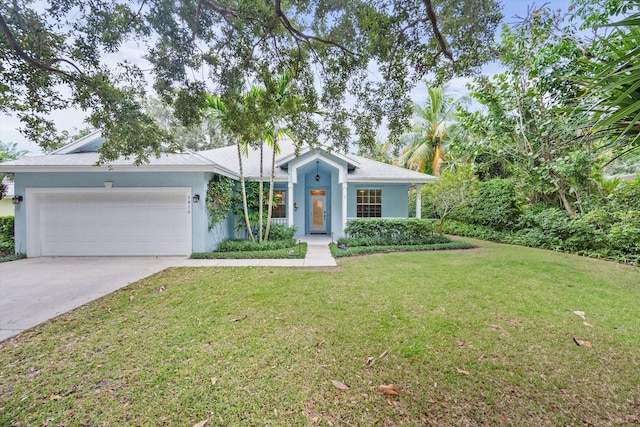 ranch-style house featuring a front yard and a garage