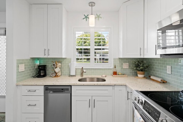 kitchen with white cabinetry, sink, tasteful backsplash, pendant lighting, and appliances with stainless steel finishes