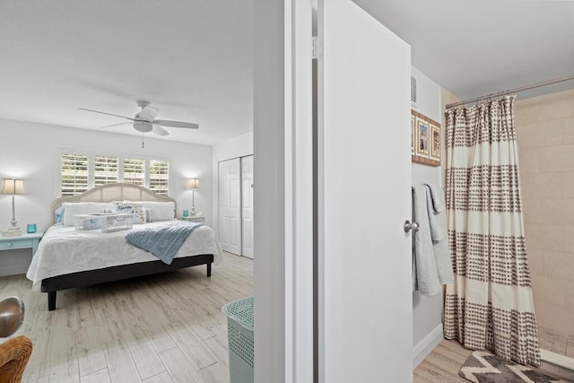 bedroom with ceiling fan, a closet, and light hardwood / wood-style floors