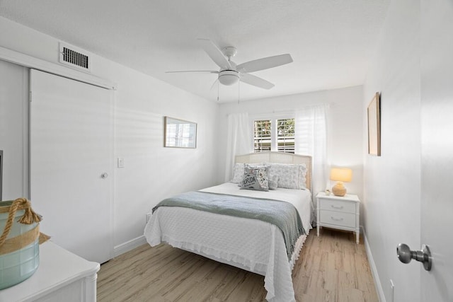 bedroom with ceiling fan and light hardwood / wood-style flooring