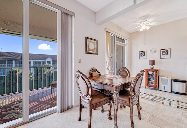 tiled dining room with ceiling fan