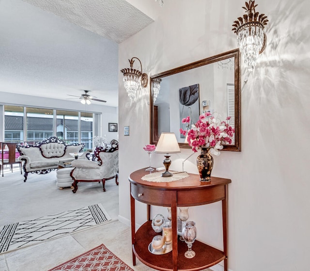 hall with a chandelier, light tile patterned floors, and a textured ceiling