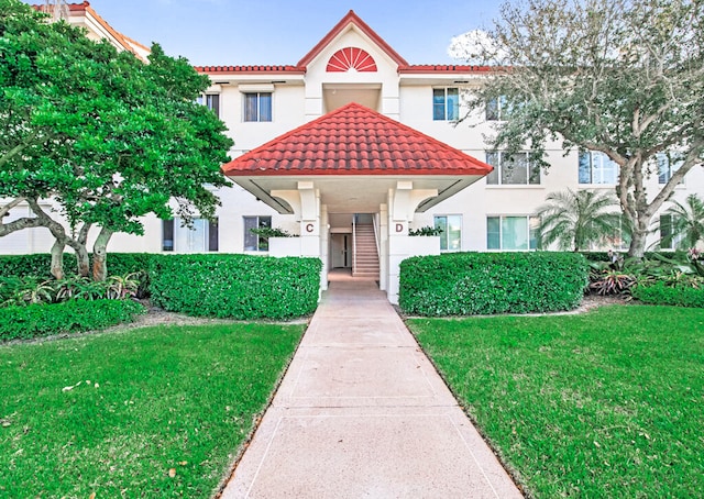 mediterranean / spanish house with a front yard