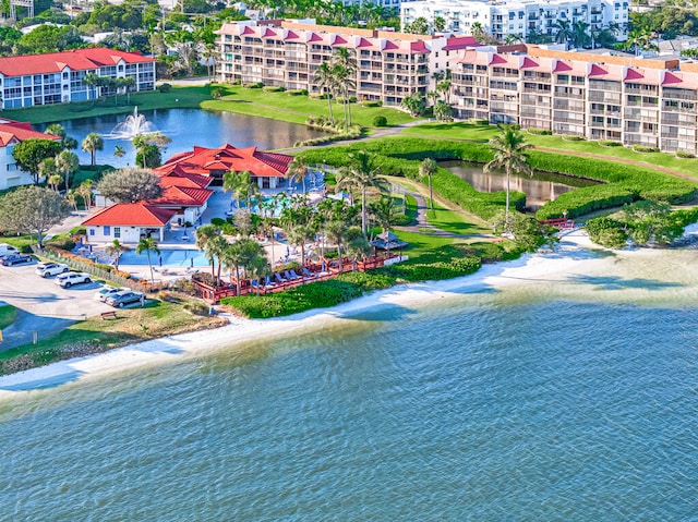 drone / aerial view featuring a water view and a view of the beach