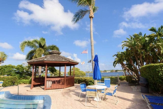 view of patio / terrace featuring a gazebo and a water view