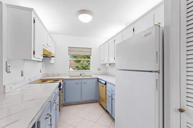 kitchen featuring white cabinets, range with electric cooktop, white fridge, and light tile patterned flooring