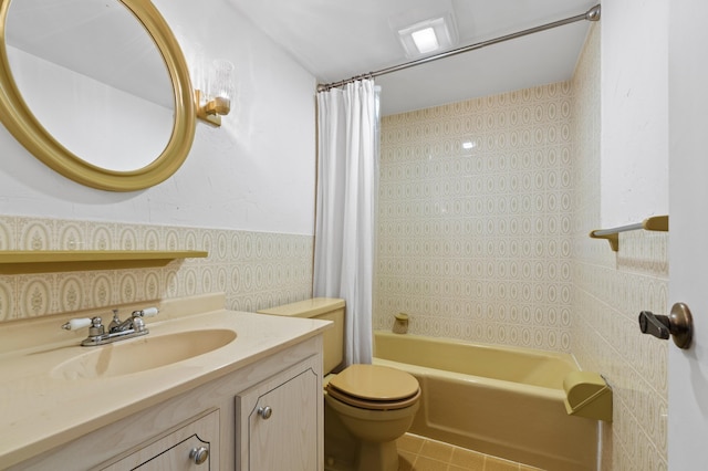 full bathroom with vanity, tile patterned flooring, toilet, tile walls, and shower / tub combo