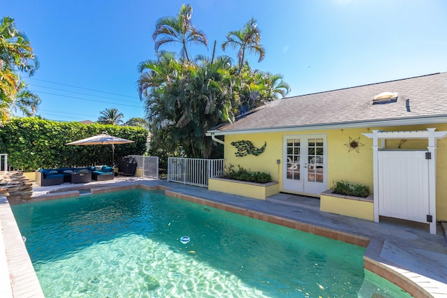 view of swimming pool with a patio area, an outdoor hangout area, and french doors